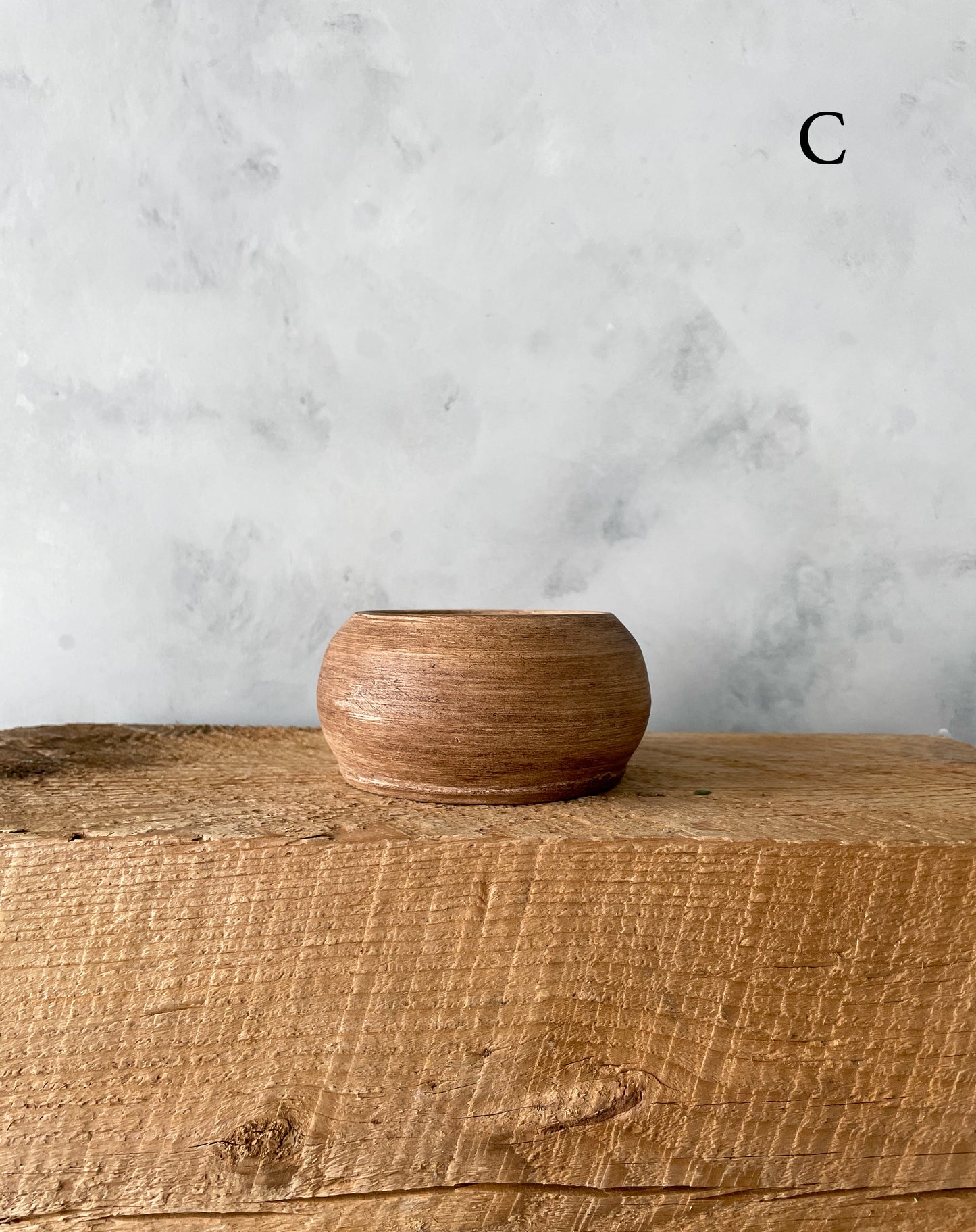 Close-up of the ceramic finish on the small dish, highlighting artisanal craftsmanship.