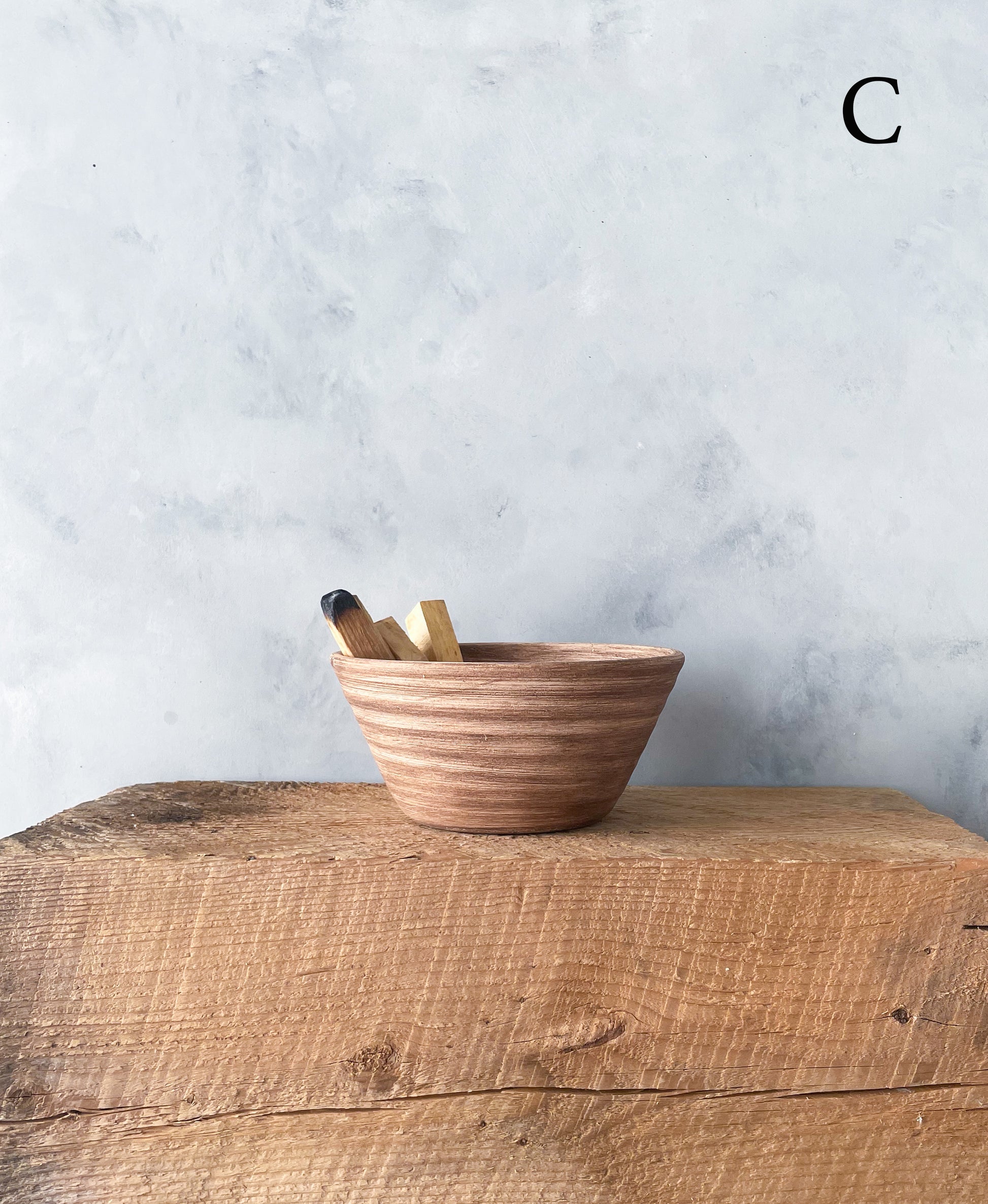 Earth Collection decorative bowl styled with sage and palo santo.