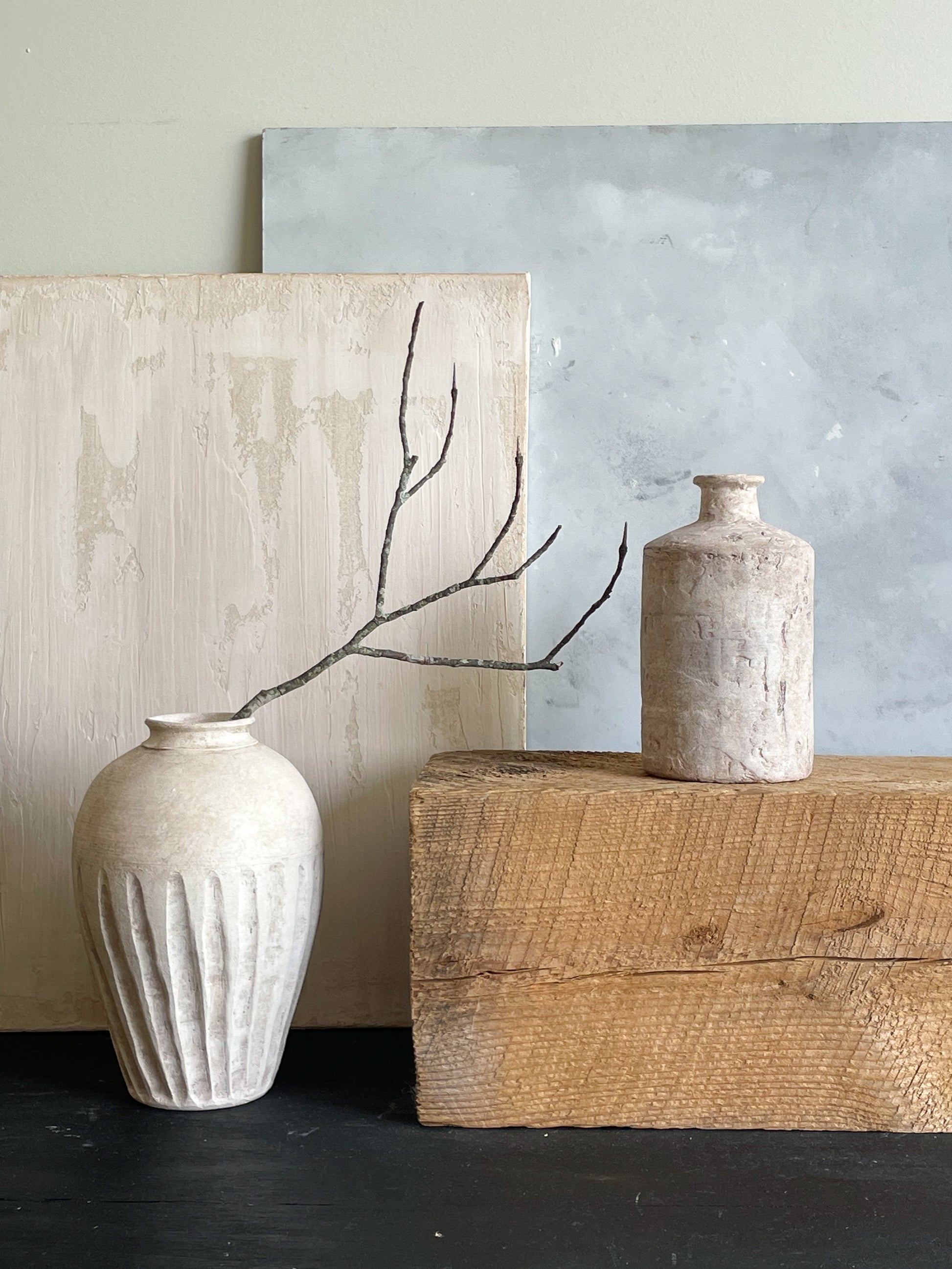 The vase paired with other neutral decor items from the Milos Collection.