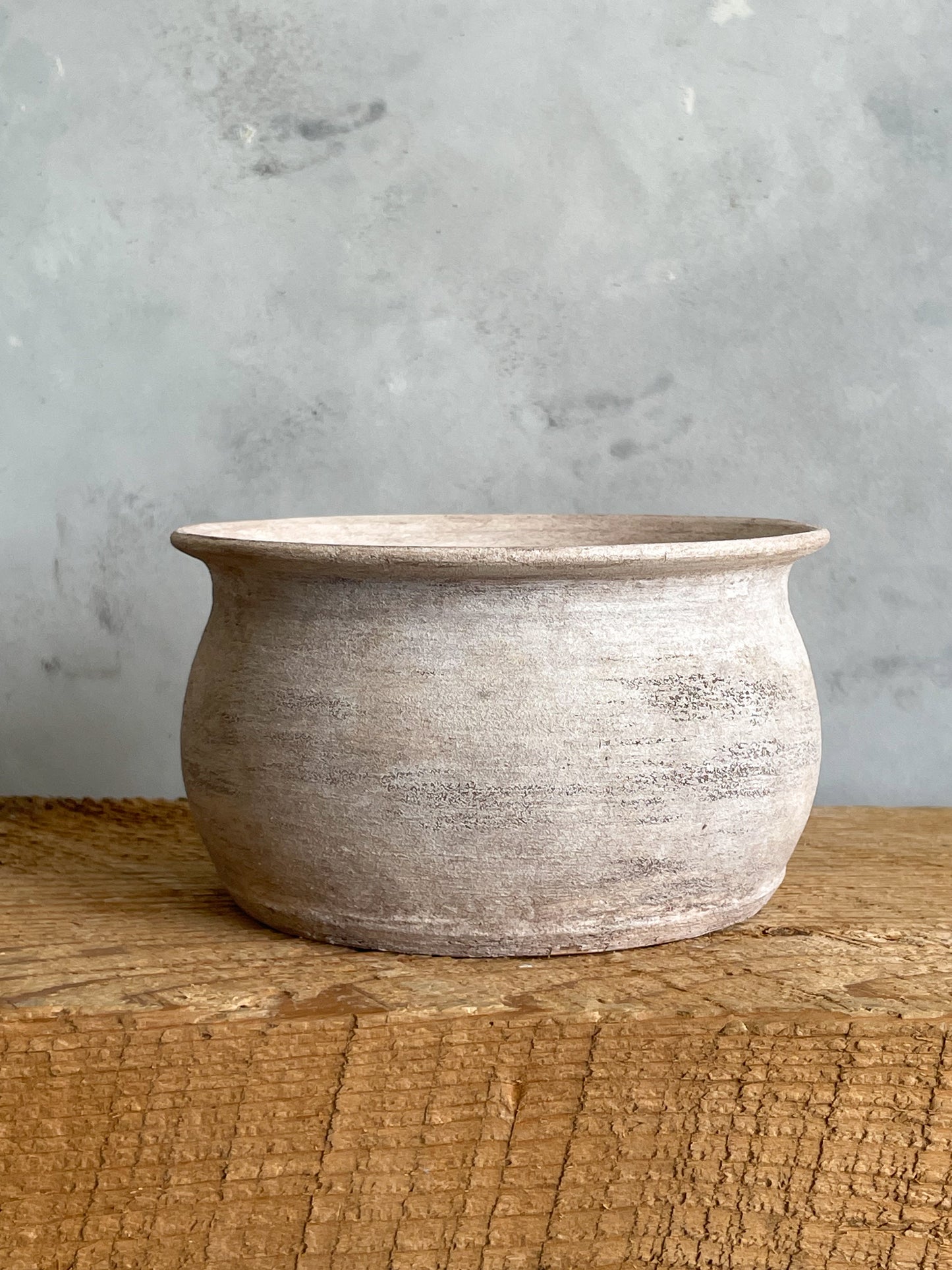 Textured ceramic planter vase on display, showcasing rustic charm