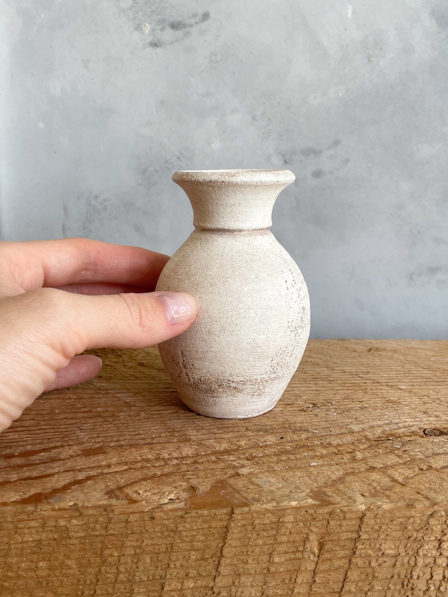 Close-up of hand-finished details on the mini vase.