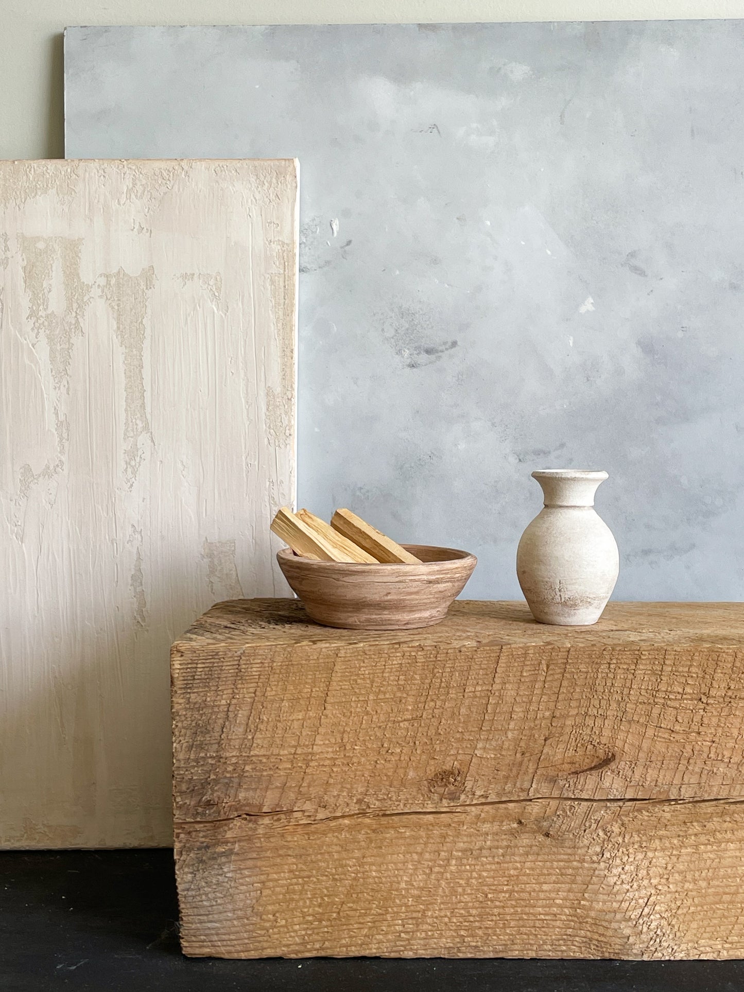 Handmade ceramic mini vase styled alongside other pottery pieces.