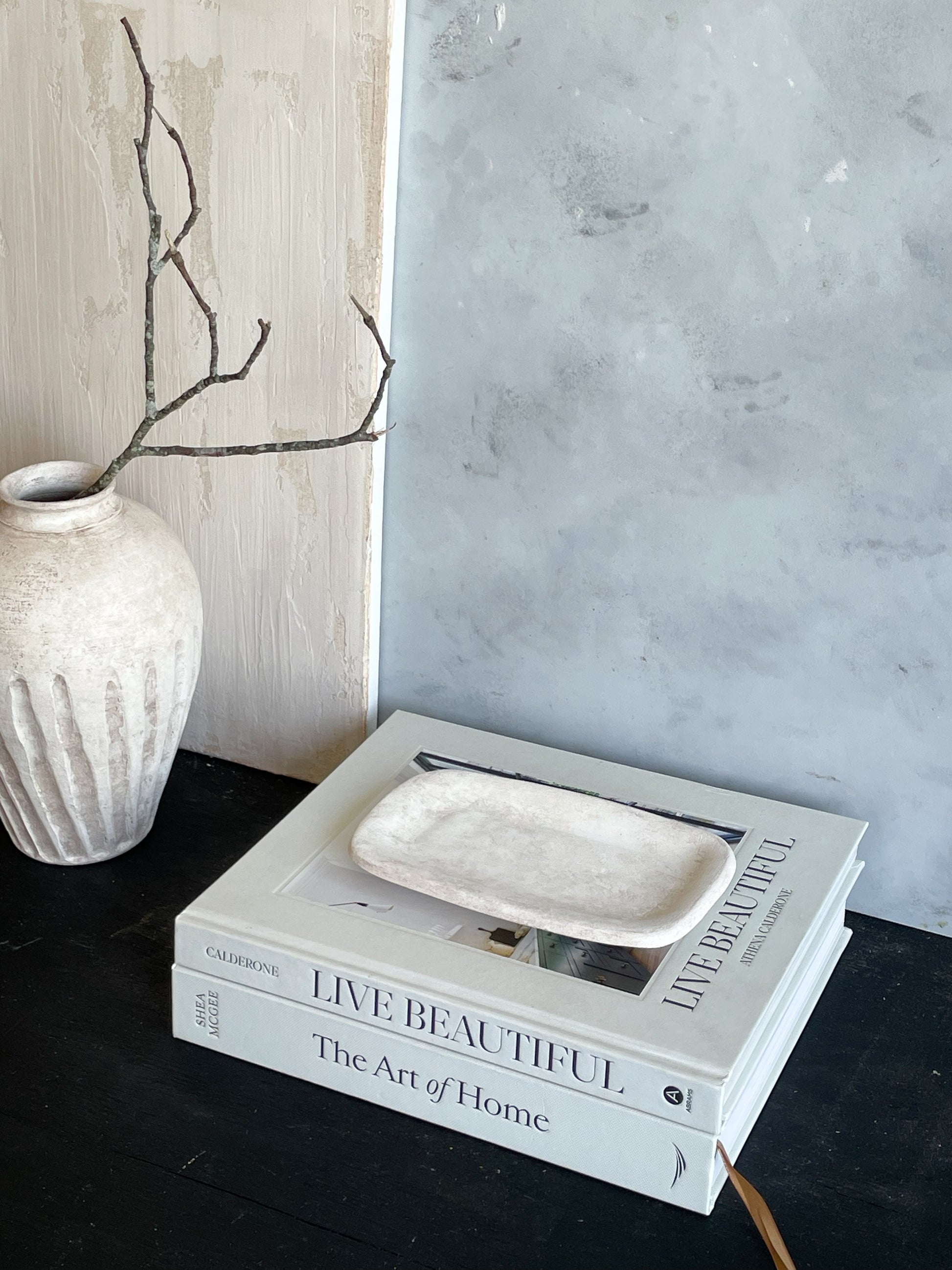 Milos Collection tray with decorative items on display in a home environment.