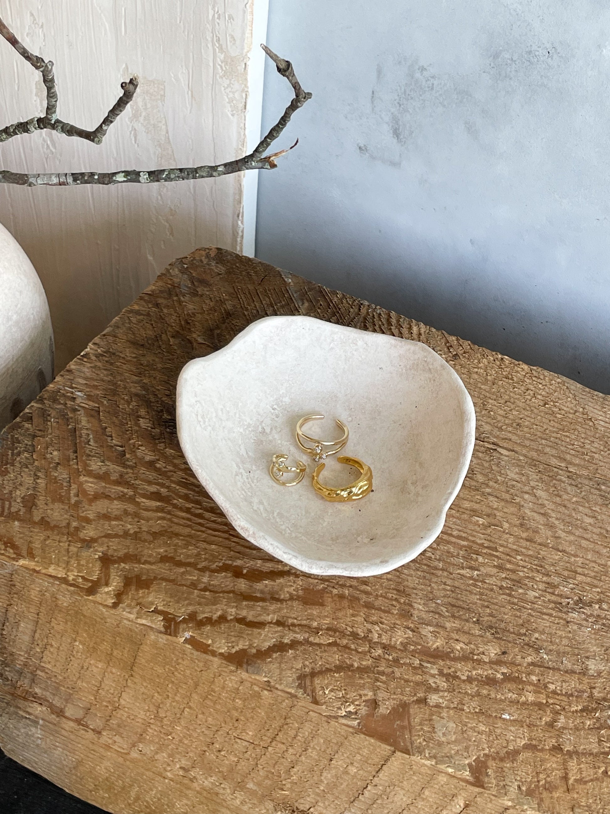 Handmade ceramic dish used as a catchall for jewelry and small items.