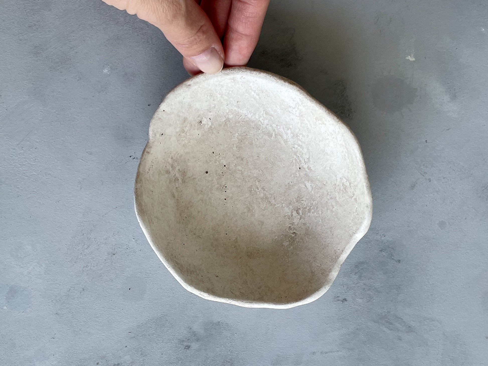 The Milos Collection rustic dish on a countertop with natural light.